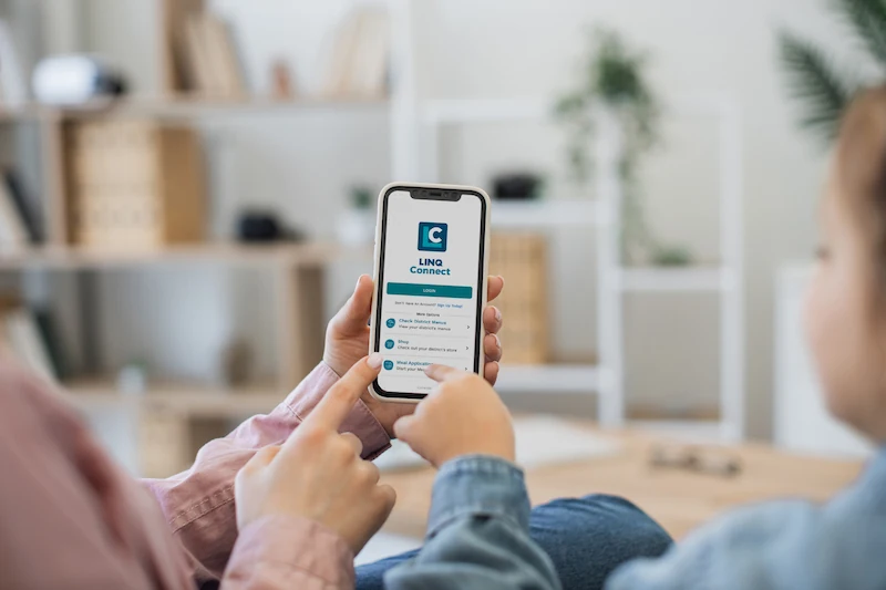 Family looking at the LINQ Connect app